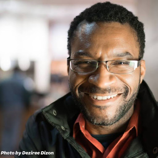 Eugene Randolph Young picture Portrait of a smiling bearded black man with glasses.